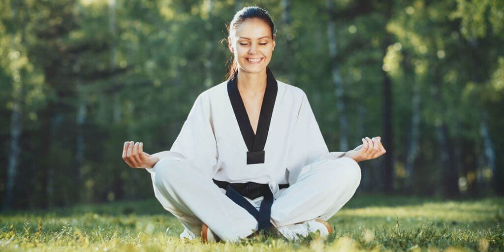 Martial Arts Lessons for Adults in Woburn MA - Happy Woman Meditated Sitting Background